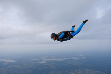 Poster - Skydiving. Girl is in the sky.