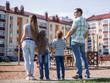 © ASDF - rear view.a young family is looking at a new apartment building