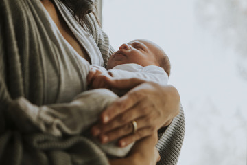 Wall Mural - mother holding her baby indoors