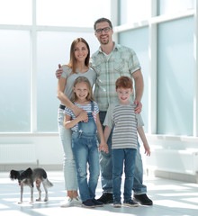 Wall Mural - family with two children standing in a new house