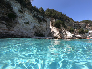 Sea level underwater photo of tropical caribbean paradise turquoise beach in exotic island located in an ocean