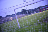 Fototapeta Sport - photograph is taken from behind the empty soccer goal