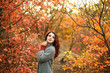 © Kate - young beautiful woman in grey coat sweather walking in autumn park with yellow and red leaves