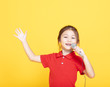 © Tom Wang - happy little girl singing on yellow background