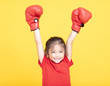© Tom Wang - happy little girl with red boxing gloves on yellow background