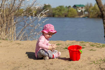 The child is playing in the sand