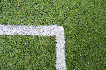 Football field with artificial surface. Green lawn, white markings. Angle.