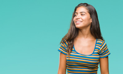 Young beautiful arab woman over isolated background looking away to side with smile on face, natural expression. Laughing confident.