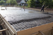 © sommersby - worker leveling fresh concrete slab with a special working tool