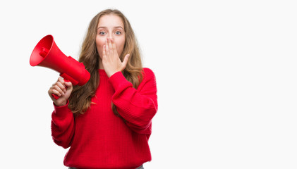 Poster - Young blonde woman holding red megaphone cover mouth with hand shocked with shame for mistake, expression of fear, scared in silence, secret concept