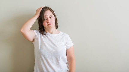 Sticker - Down syndrome woman standing over wall confuse and wonder about question. Uncertain with doubt, thinking with hand on head. Pensive concept.