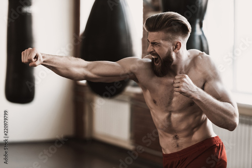 Fotografia Athletic Male Boxer Training at Boxing studio