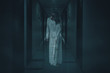 Scary female ghost walks in the hotel corridor
