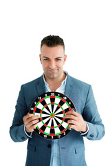 Businessman holding a dart board The traces of many games. The competition in the business world requires expertise and understanding of the target audience to succeed at strategic planning.