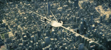 UAV  Armed Reconnaissance And Attack Drone Flying High Above A Metropolitan City. 3d Rendering