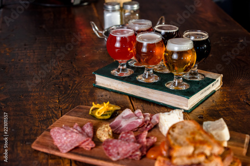 A Flight Of Beer With A Plate Of Pub Food