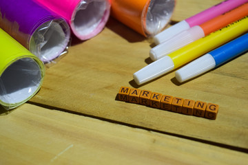 Marketing on wooden cubes with colorful paper and pen, Concept Inspiration on wooden background