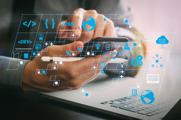 Fototapete - close up of businessman working with mobile phone and stylus pen and laptop computer on wooden desk in modern office