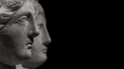 Marble ancient heads of women watching ahead into distance