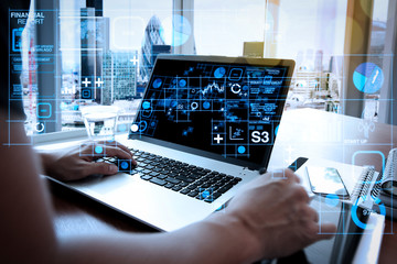 Poster - businessman hand working with new modern computer and smart phone and business strategy on wooden desk as concept