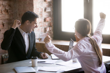 Happy cheerful and successful man and woman at office celebrating and screaming, got deal or reward. Good deal, success and win concept