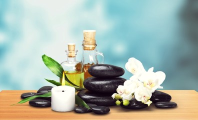 Wall Mural - Zen basalt stones and aroma oil on the white