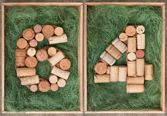 Wall Mural - Number 64  sixty four  made of wine corks on green background in wooden box