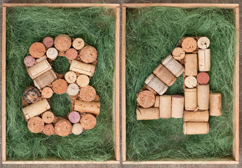 Wall Mural - Number 84  eighty four made of wine corks on green background in wooden box