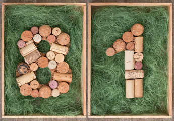 Wall Mural - Number 81 eighty one  made of wine corks on green background in wooden box