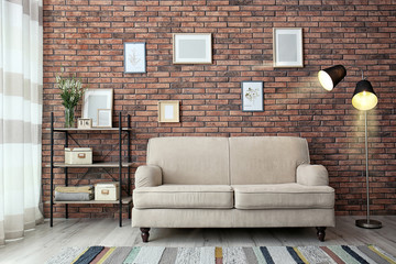 Poster - modern living room interior with comfortable sofa near brick wall