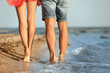 Young couple spending time together on beach, closeup of legs