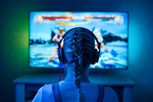 A Girl Is A Gamer Or A Streamer In Front Of A Television Playing.It Is Possible To Use As A Background