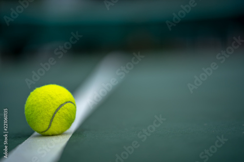 Fotomural The beginning of a champion, Close up tennis ball on the courts background