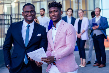 Successful multinational professionals team portrait, multi-ethnic group of confident business people , company ceo boss and employees posing on the street together