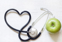 Alternative Medicine Healthy  Sign Concept With Stethoscope Heart And Green Apple On White Background
