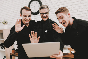 Wall Mural - Smiling Police Officers Are Staring On Laptop.