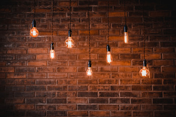 Decoration antique edison light bulbs background red brick wall