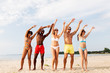 © Syda Productions - friendship, summer holidays and people concept - group of happy friends having fun on beach