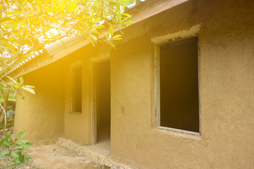 Earth house traditional of clay and straw with the sunlight.