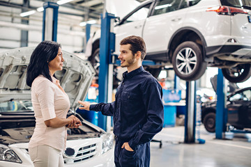 Wall Mural - Auto car repair service center. The mechanic communicates with the client