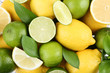 Background of lemons and limes with green leafs