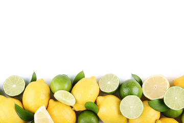 Poster - Lemons and limes with green leafs on white background