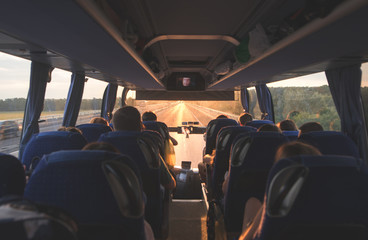 bus with people going on the road in the evening at sunset. photo interior of the bus. background. b