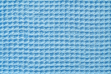 Closeup view of a light blue waffle fabric as background, texture