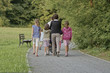 rodzina spaceruje  w parku, kochająca się rodzina na spacerze w parku, odpoczynek na świeżym powietrzu, rodzinne spacery