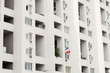 Minimalist architecture. Residential tower with bright light and white color. France flag hanging