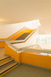 Interior large staircase with yellow bright colors and light