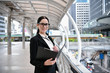 © S photographer - Business concept. Young businesswoman is working in business district. Young businesswoman happy to work.
