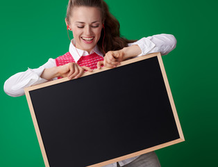 Wall Mural - happy young student woman in headphones looking at blackboard