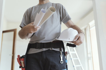 Wall Mural - Construction engineer holding safety helmet and projects